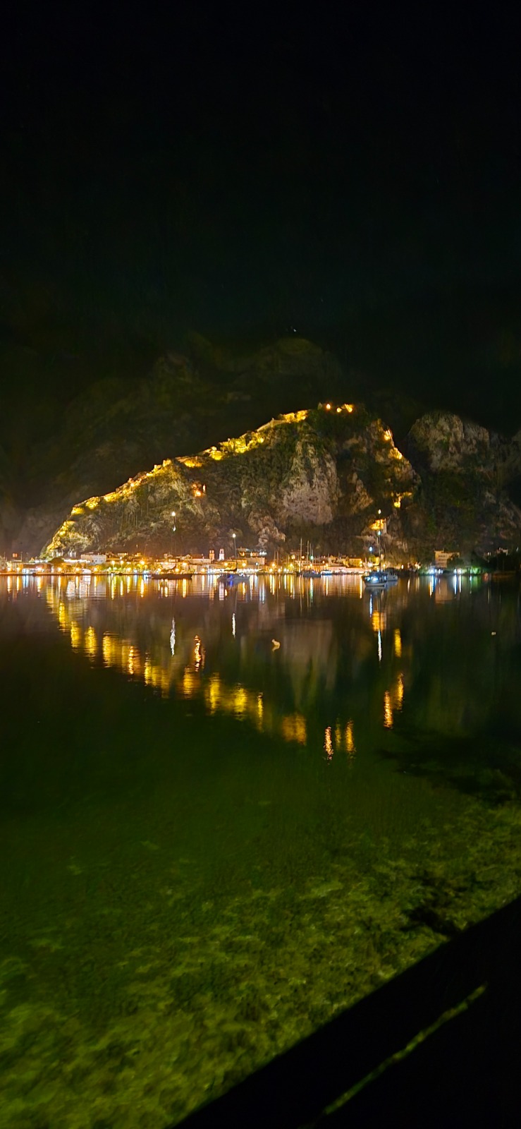 Illuminated old town beside still water