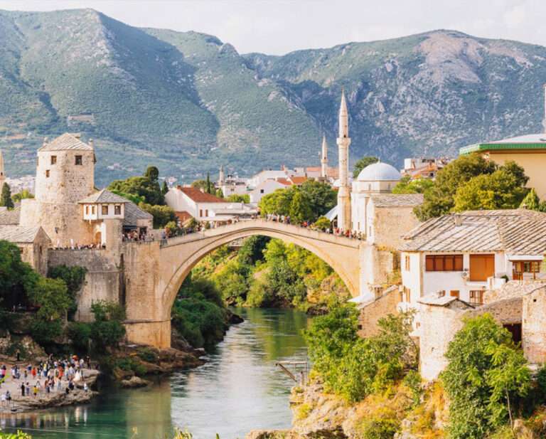 Historic Bosnian town surrounded by dramatic green mountains